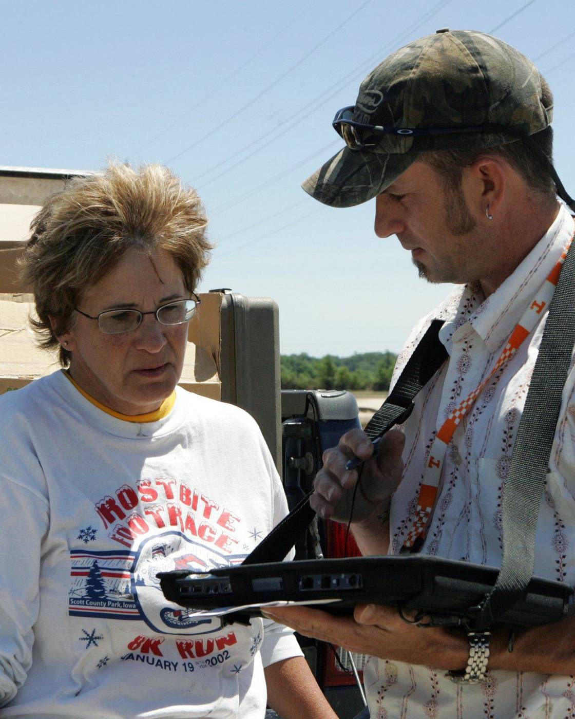 Homeowner answering an inspector's questions about damage to her home