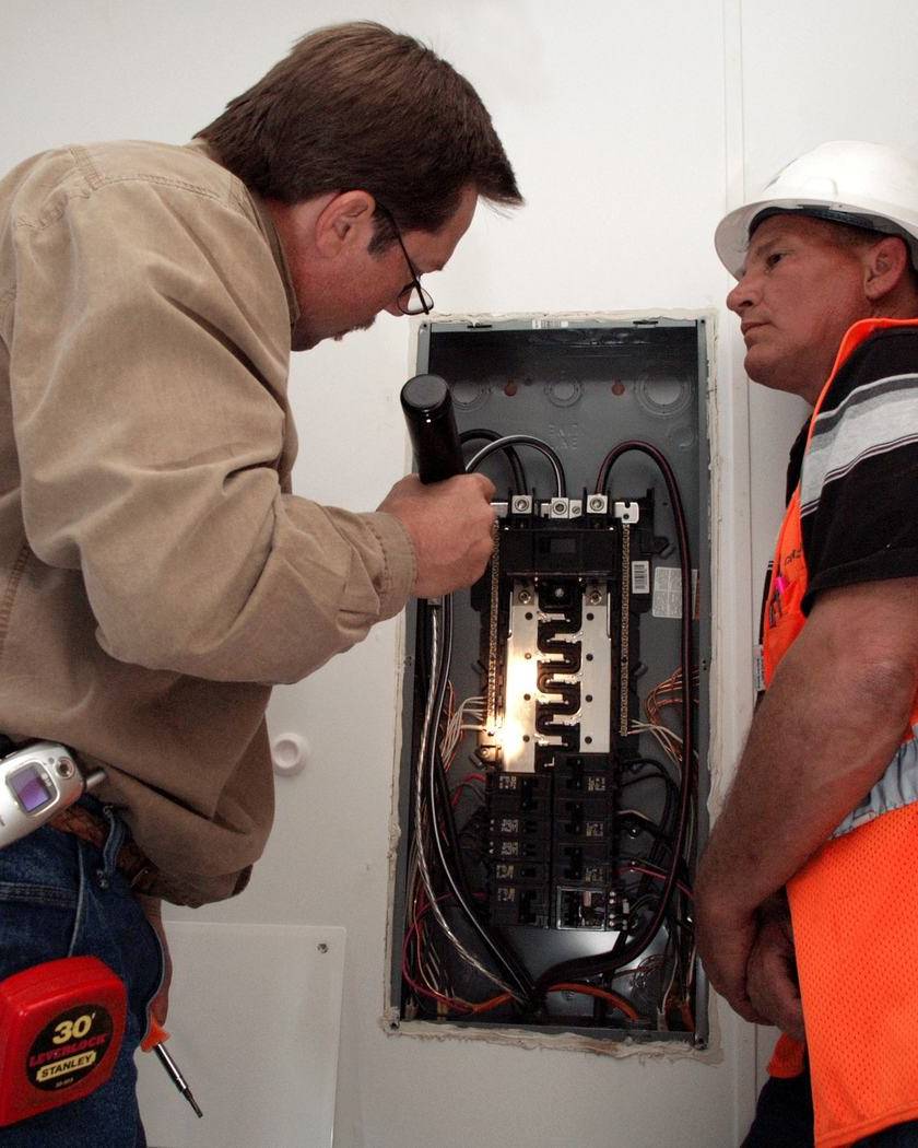 Inspector checking the electrical panel of a home