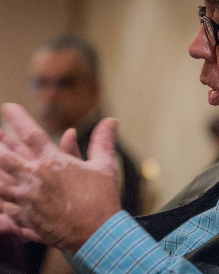 Man explaining a point with his hands during a meeting
