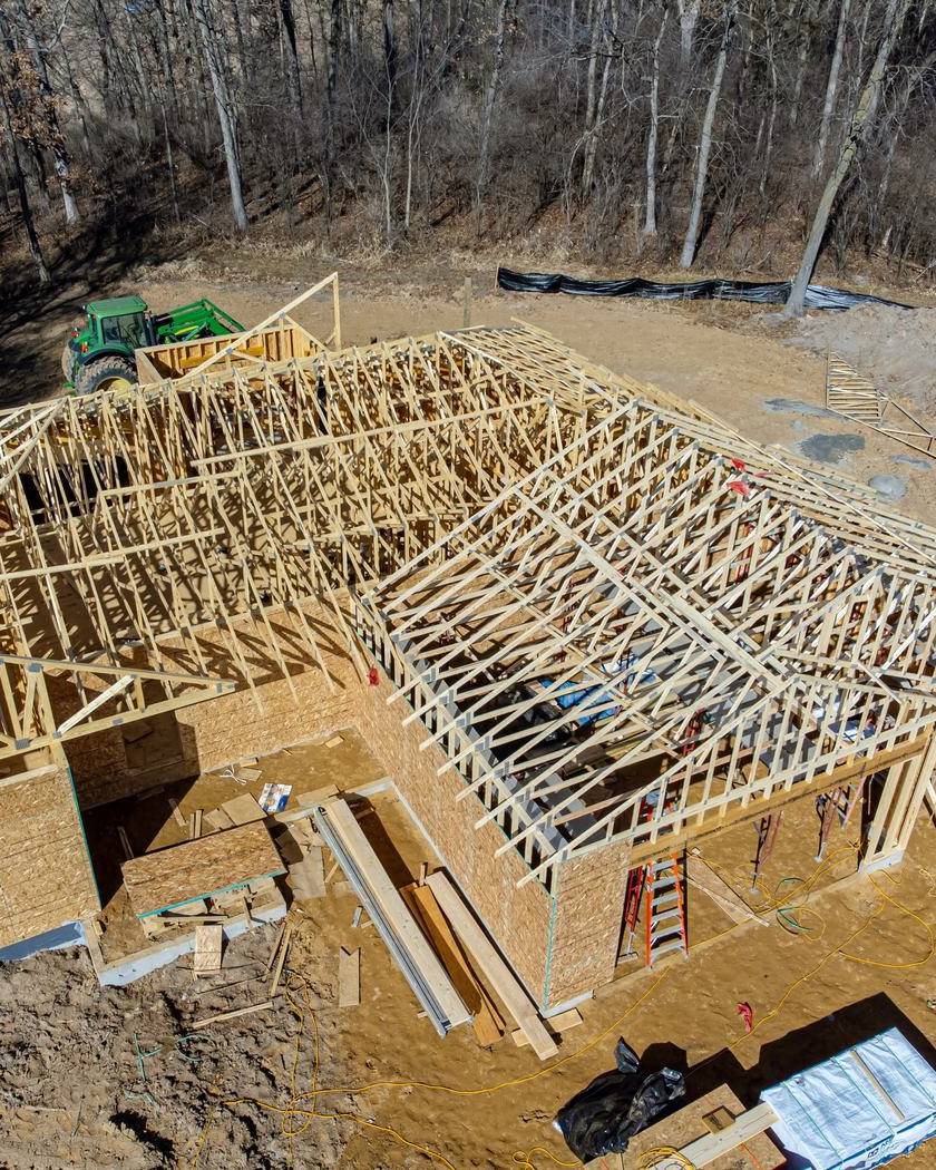 Wood frame of a new house going up on a cleared lot