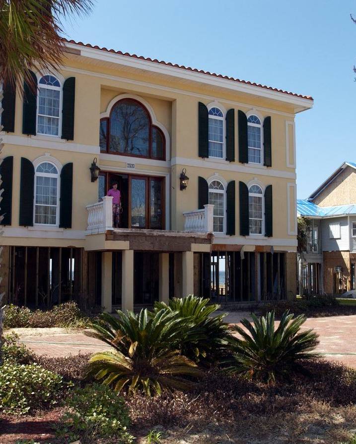 Resident showing hurricane damage to her home in Pensacola, Florida