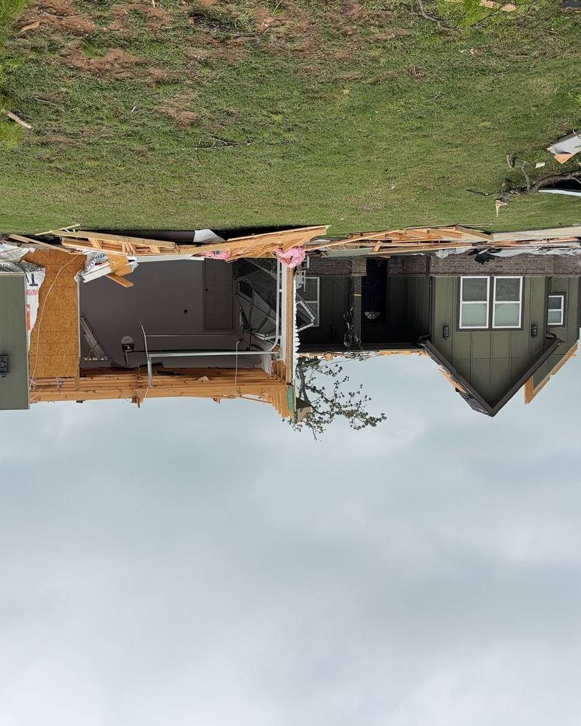 Home with most of its roof torn off by a tornado