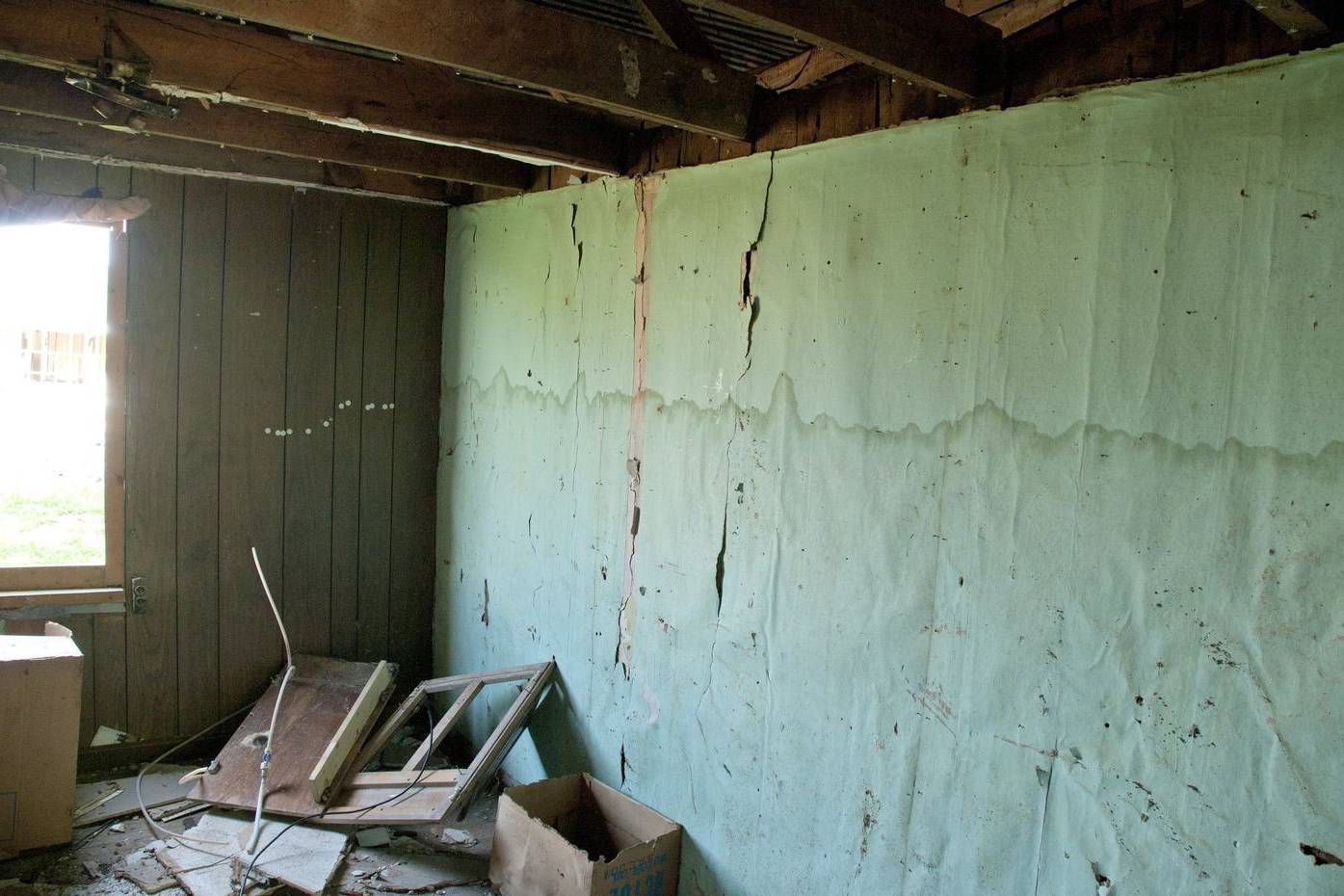 Flood water line still visible on the wall of an empty room