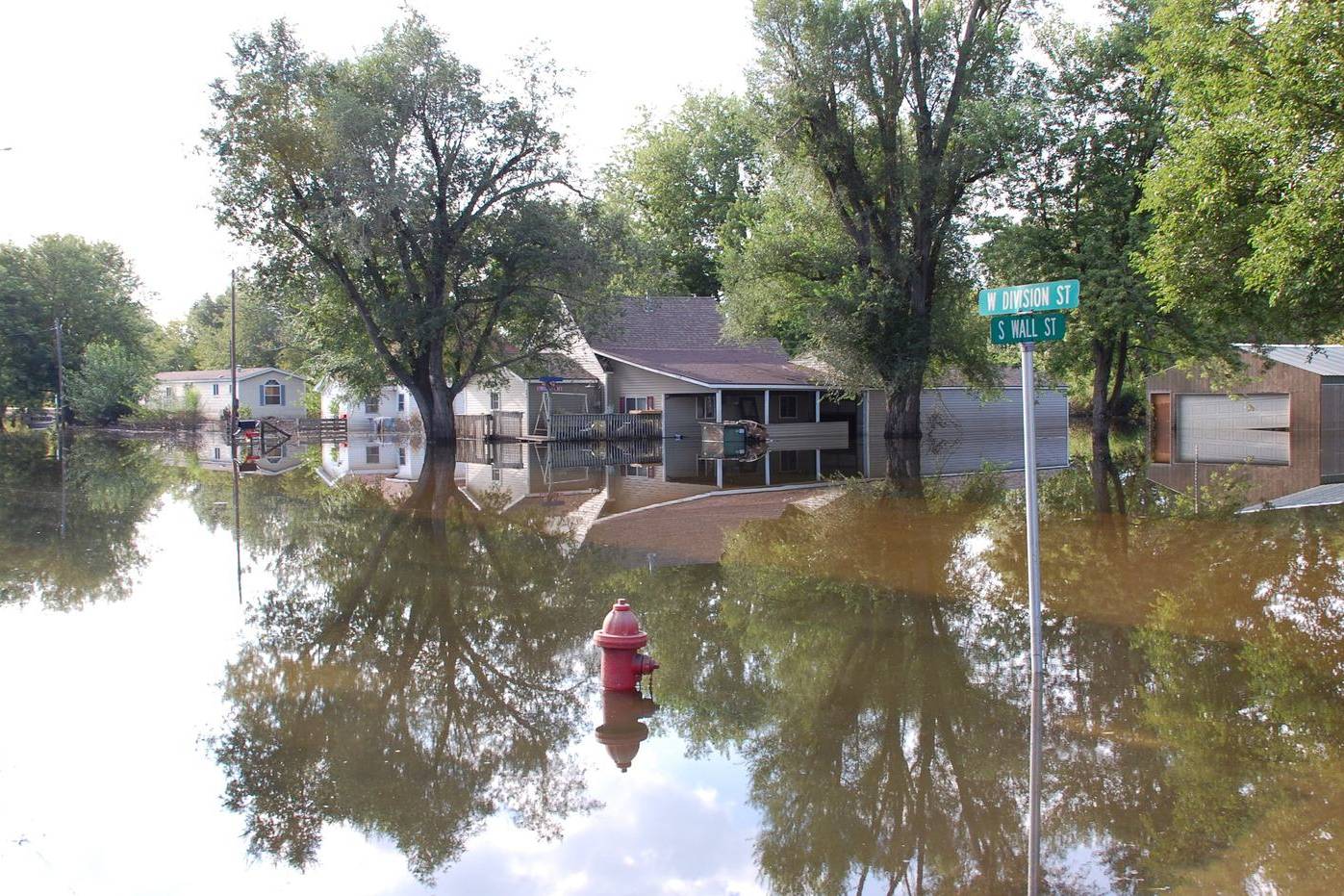 Flooded neighbourhood street with water up to the houses