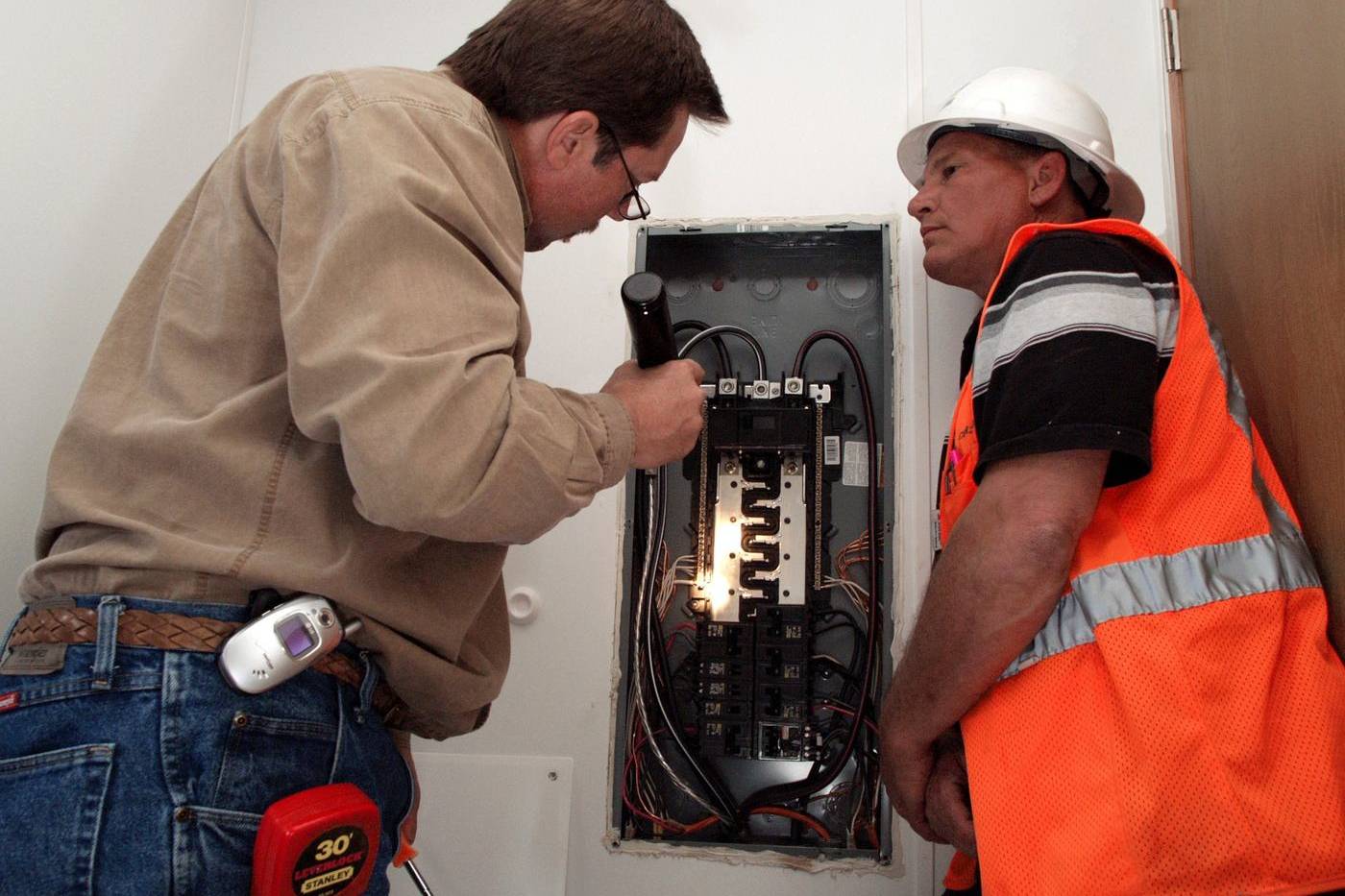 Inspector checking the electrical panel of a home