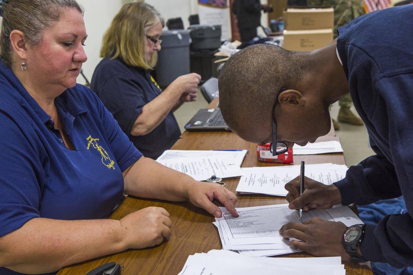 People filling out forms at a table
